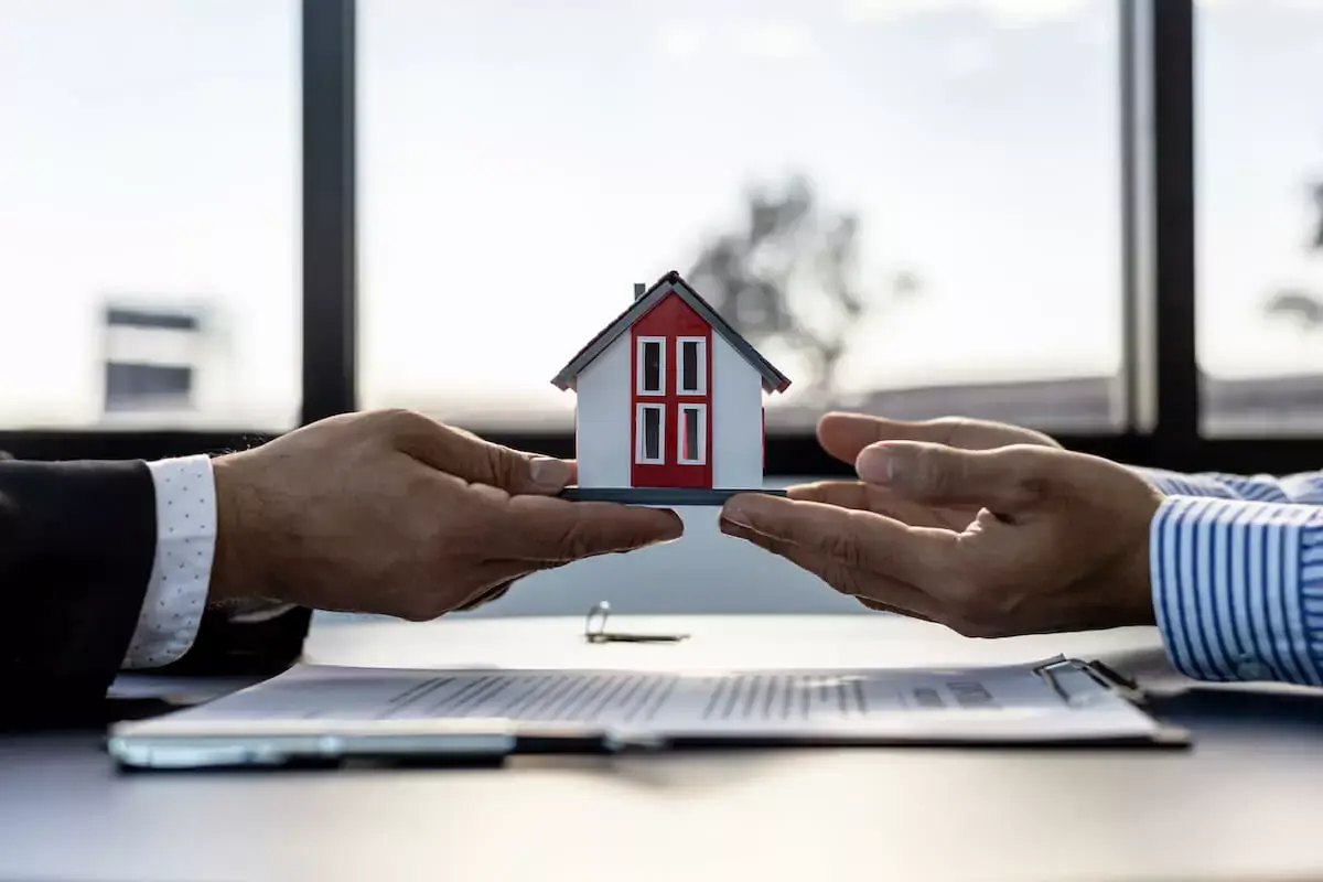 2-people-holding-a-miniature-house.jpeg