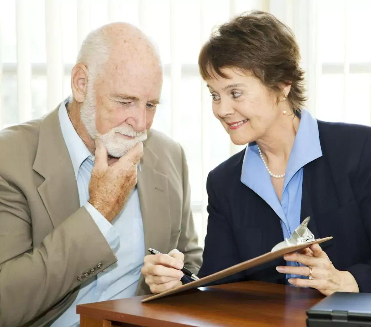 Elderly-man-thinking-about-signing-a-document.jpg