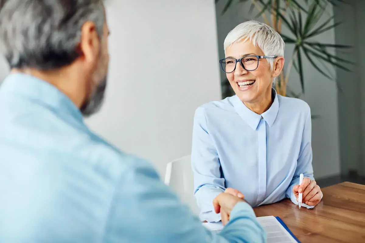 Elderly-woman-shaking-hands-with-a-man.jpg