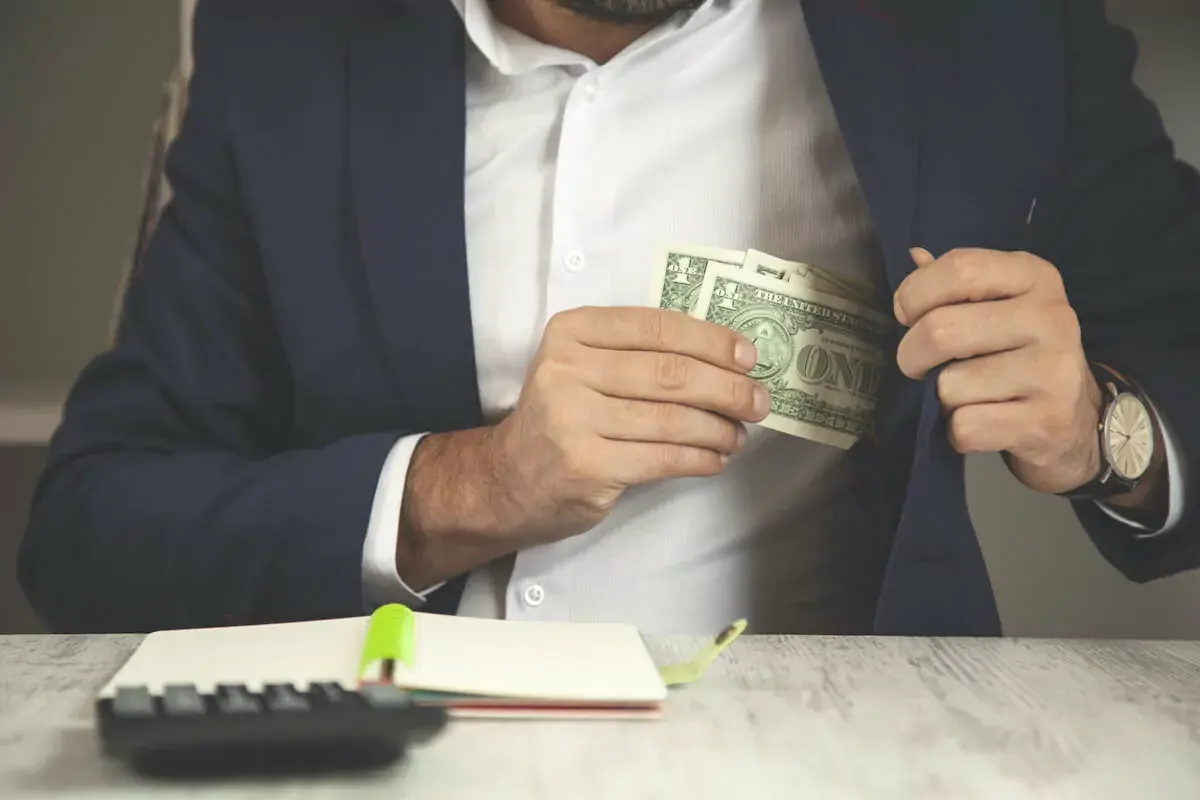 Man-putting-money-in-his-pocket.jpg