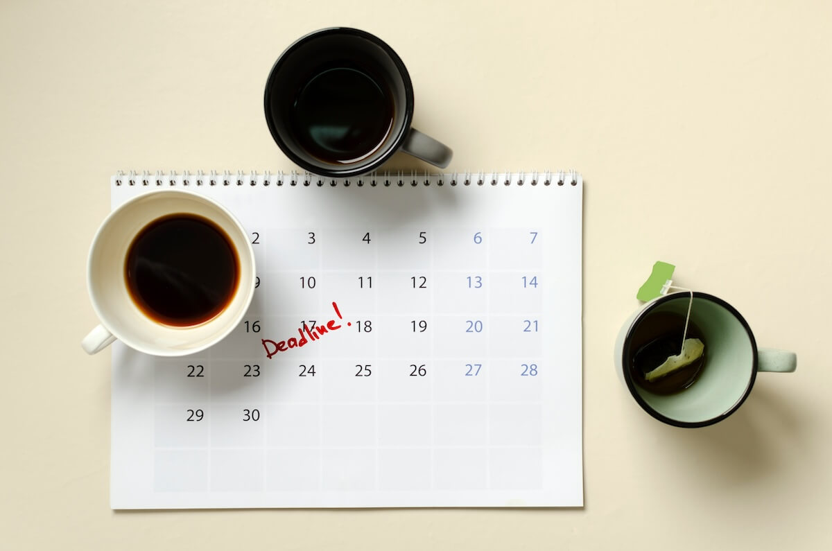 A desk calendar with three coffee cups