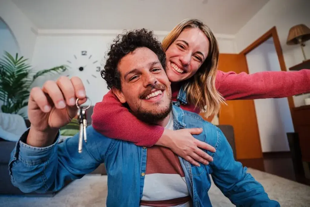 couple-smiling-at-the-camera-while-holding-their-house-keys-1024x683.jpeg