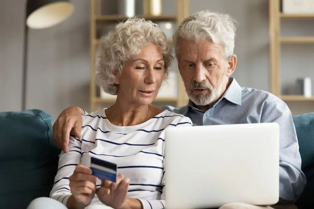 couple-using-a-laptop-and-holding-a-credit-card.jpeg