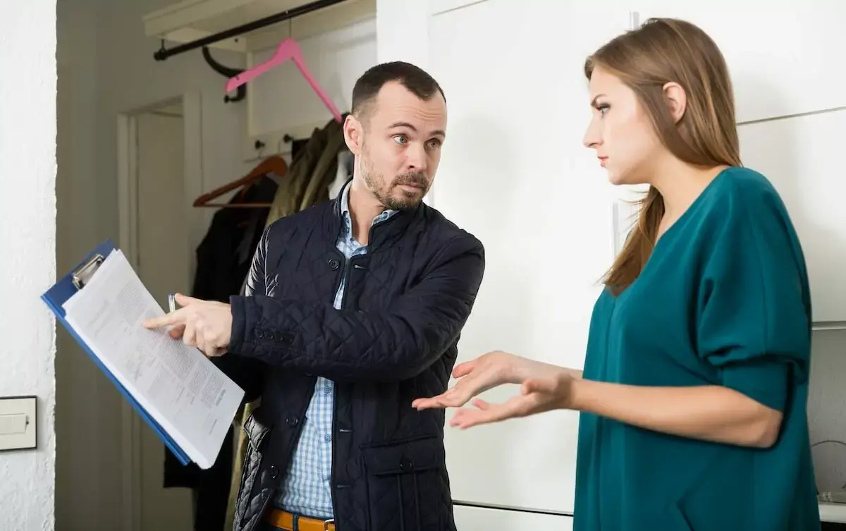debt-collector-showing-a-document-to-a-woman.jpeg