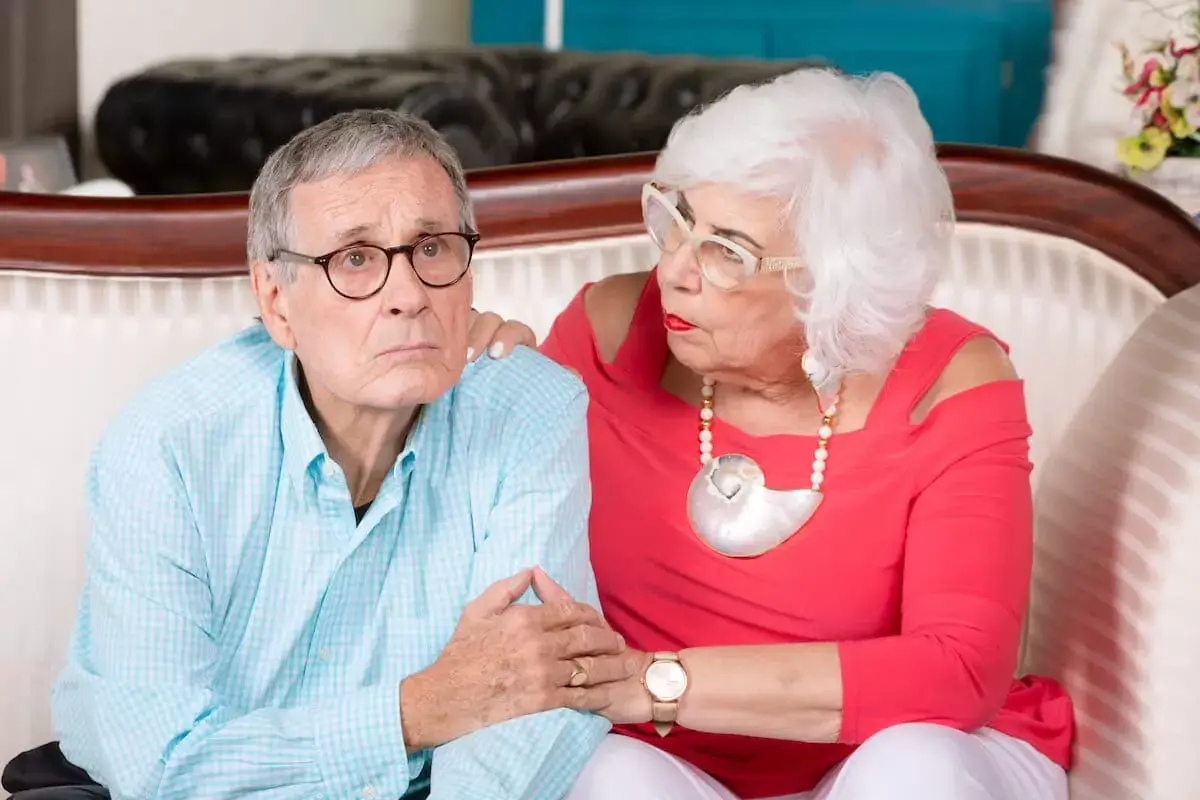 elderly-woman-comforting-a-worried-elderly-man.jpeg
