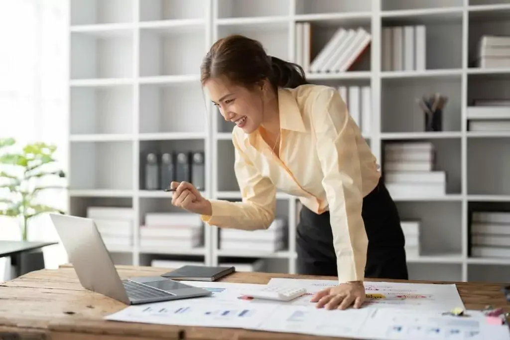 entrepreneur-happily-looking-at-her-laptop-1024x683.jpeg