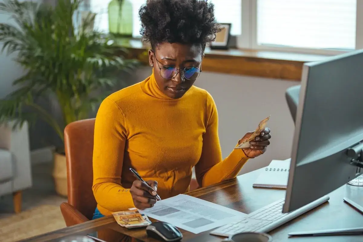 entrepreneur-reading-a-document-while-holding-a-bill.jpeg