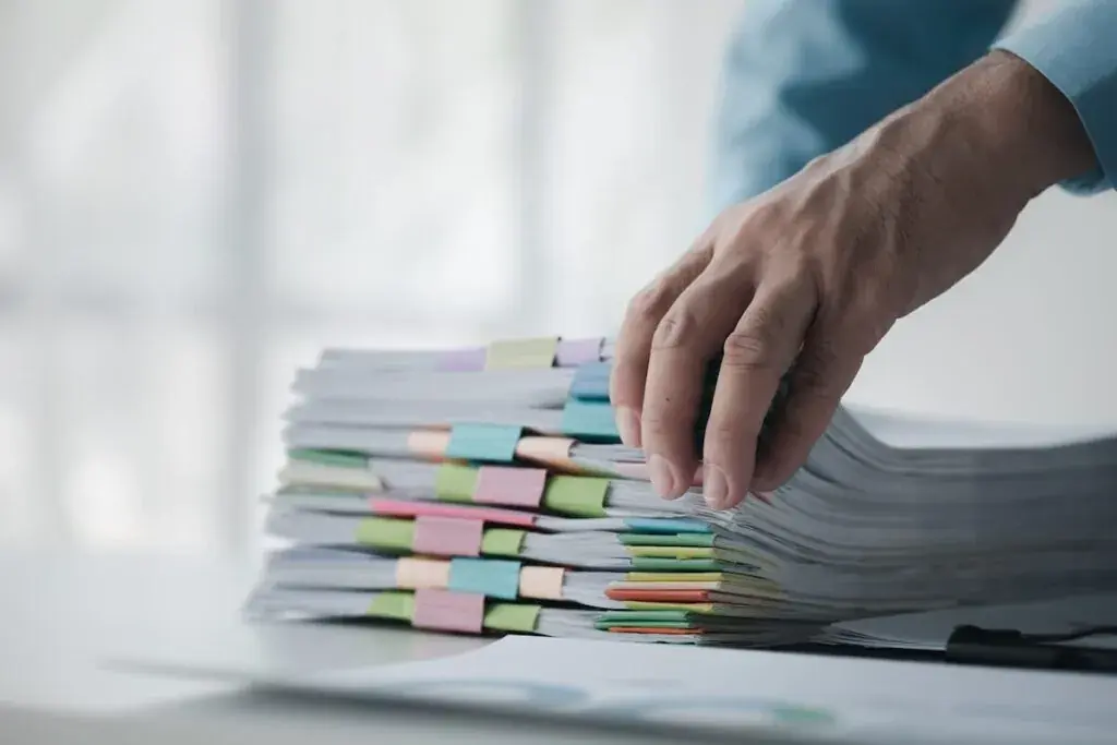 hand-holding-a-stack-of-documents-1024x683.jpeg