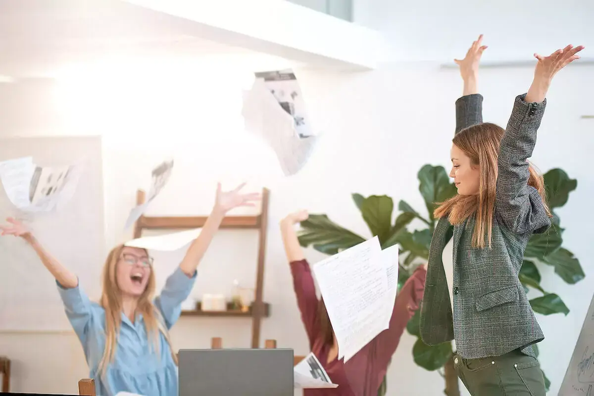 happy-team-throwing-papers.jpeg