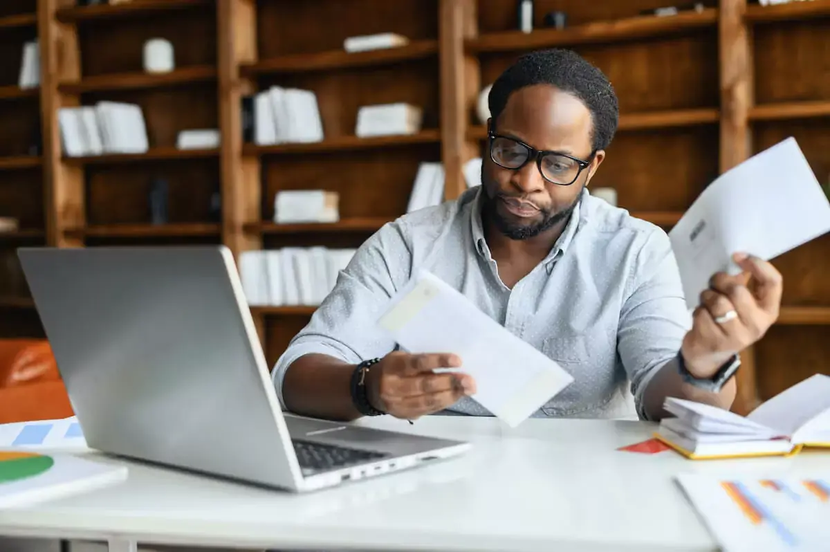 man-looking-through-bills.jpg