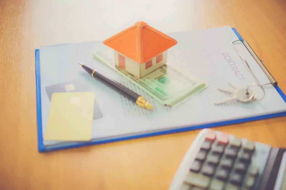 miniature-house-keys-pen-and-a-contract.jpeg