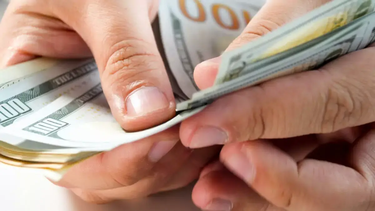 person-counting-bills.jpeg