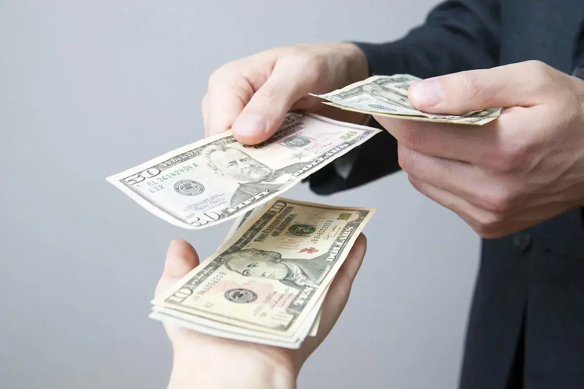 person-handing-cash.jpeg