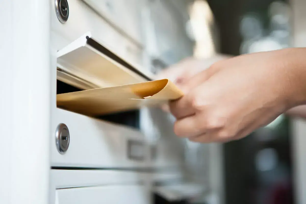 person-putting-an-envelope-in-a-mailbox.jpeg