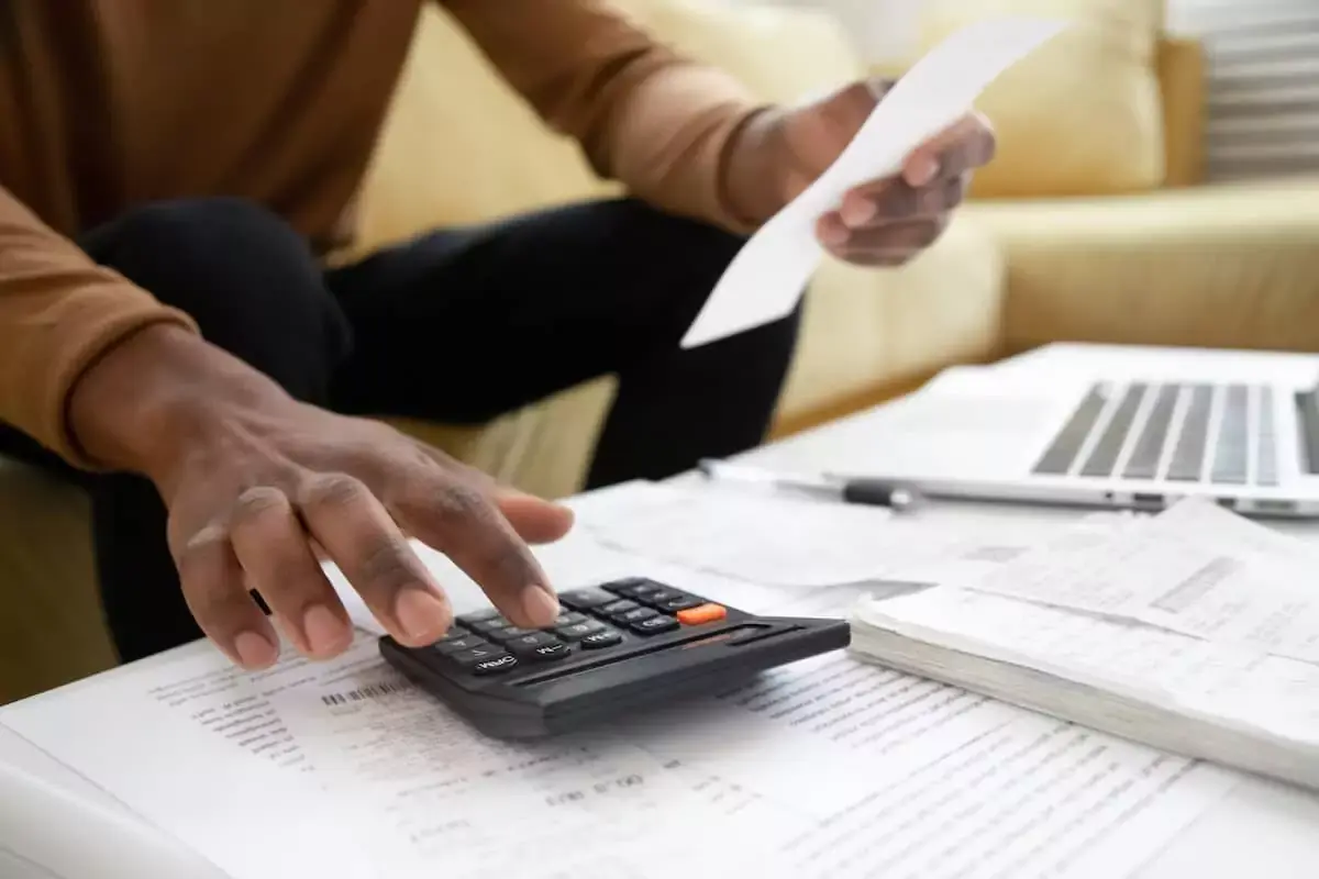 person-using-a-calculator-while-holding-a-receipt.jpeg