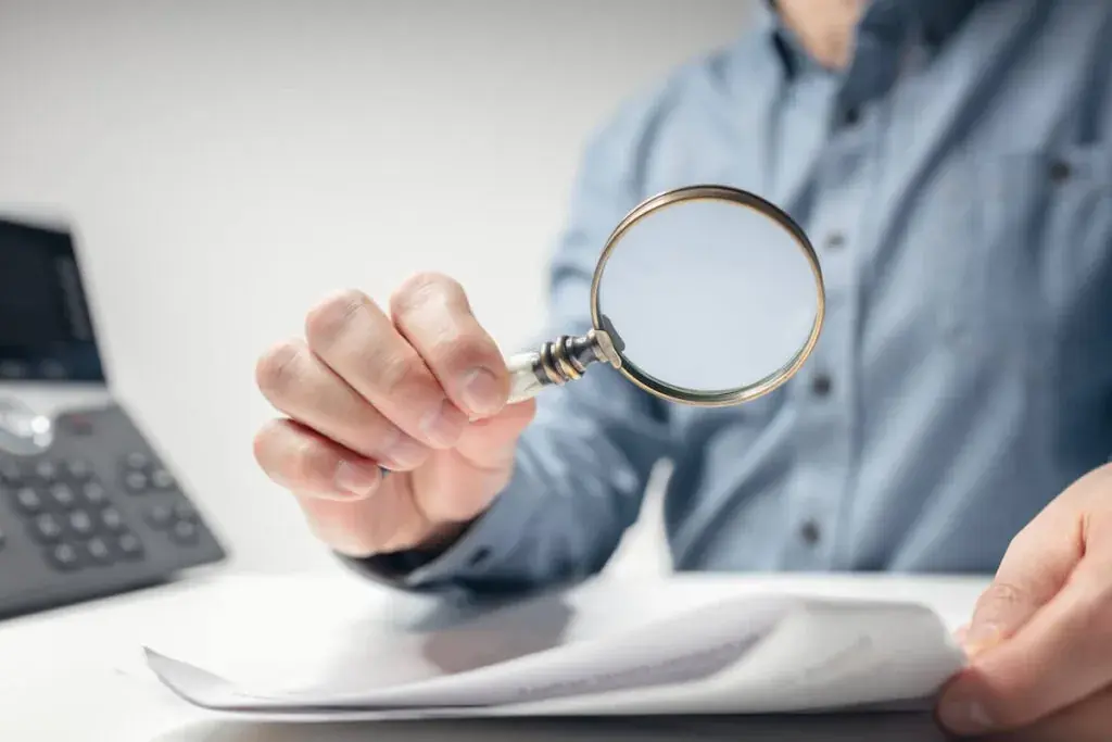 person-using-a-magnifying-glass-to-read-a-document-1024x683.jpeg