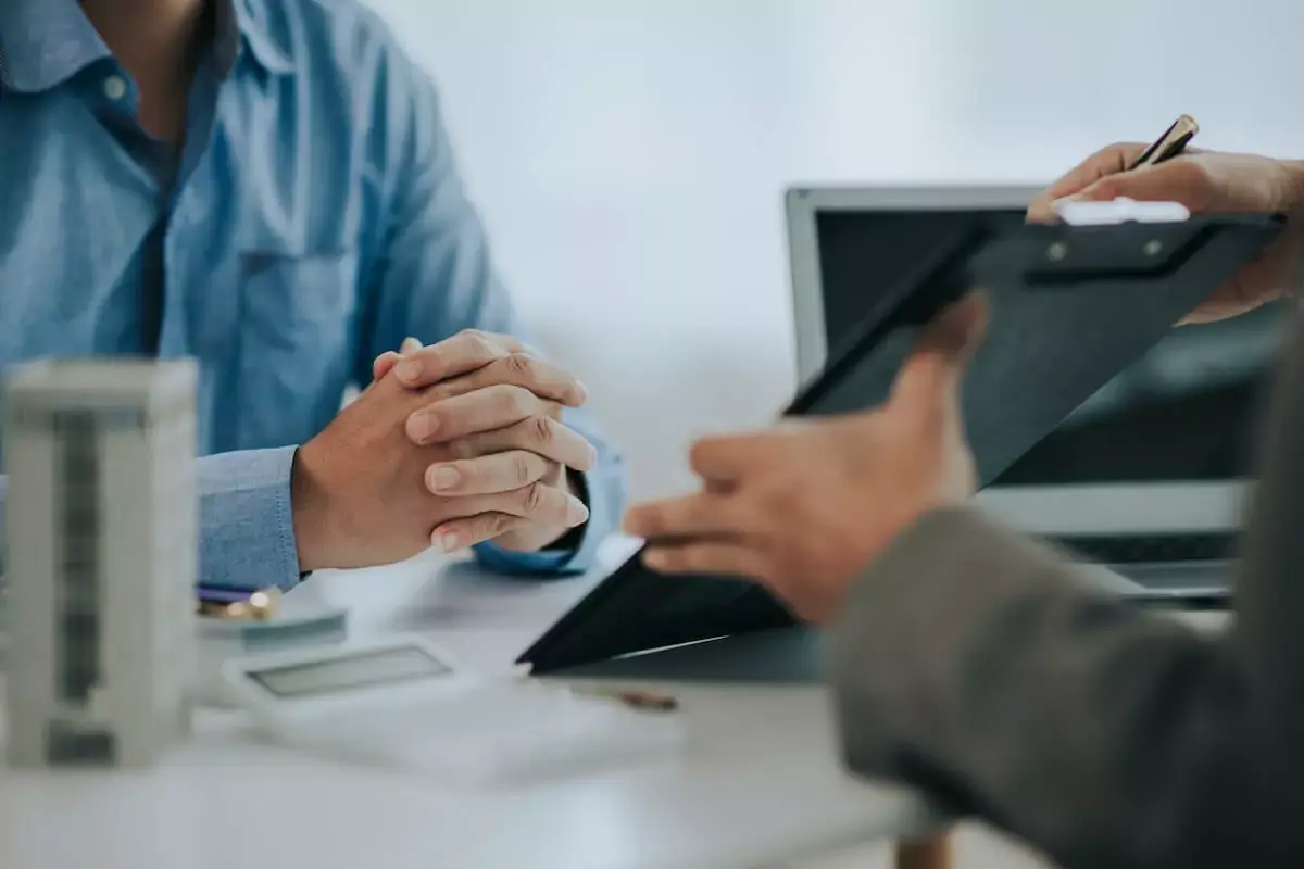 real-estate-agent-showing-a-contract-to-a-client.jpeg