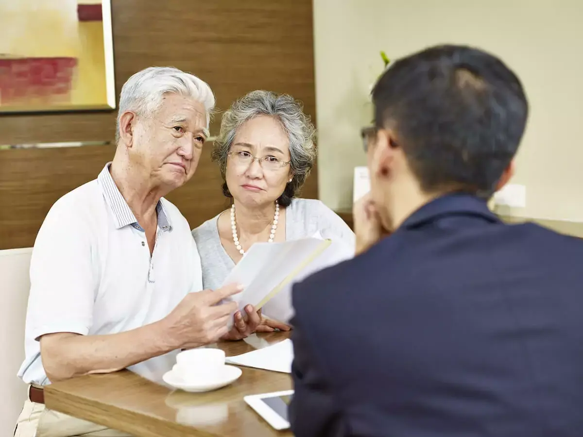 sad-old-couple-talking-to-a-sales-representative.jpg