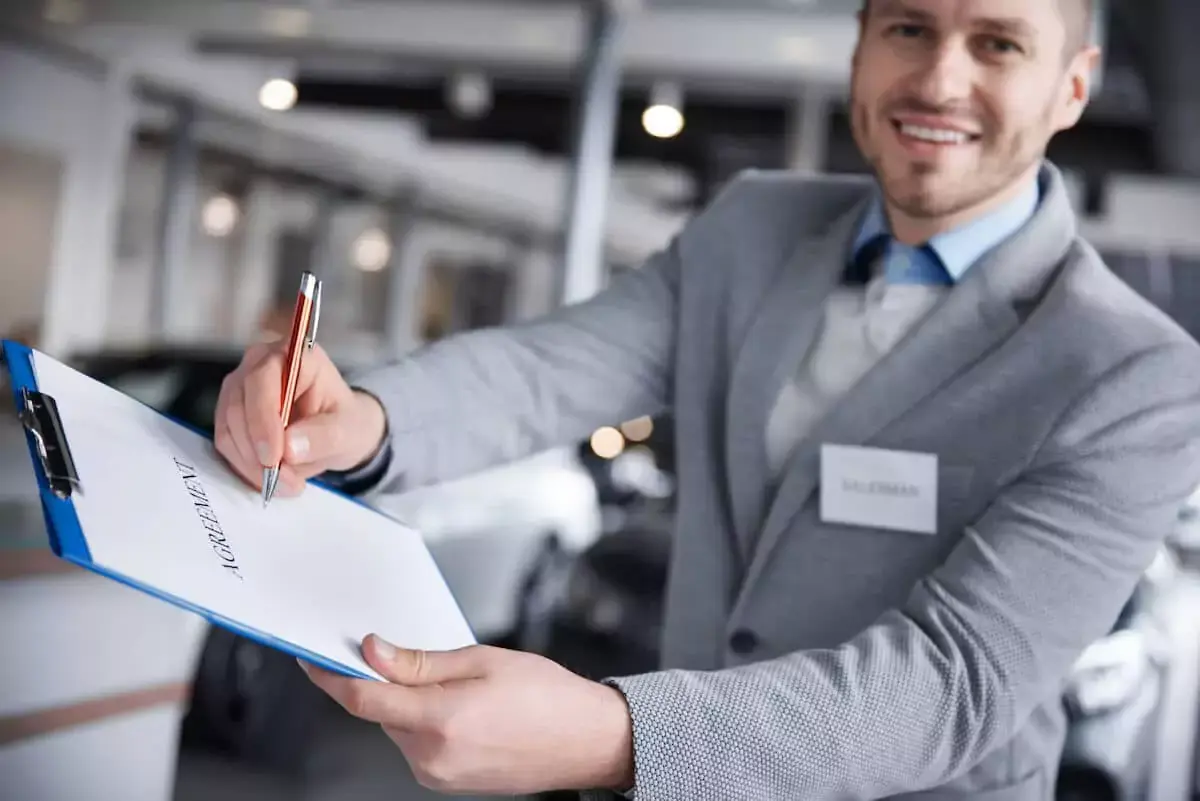 salesperson-handing-an-agreement-document.jpeg
