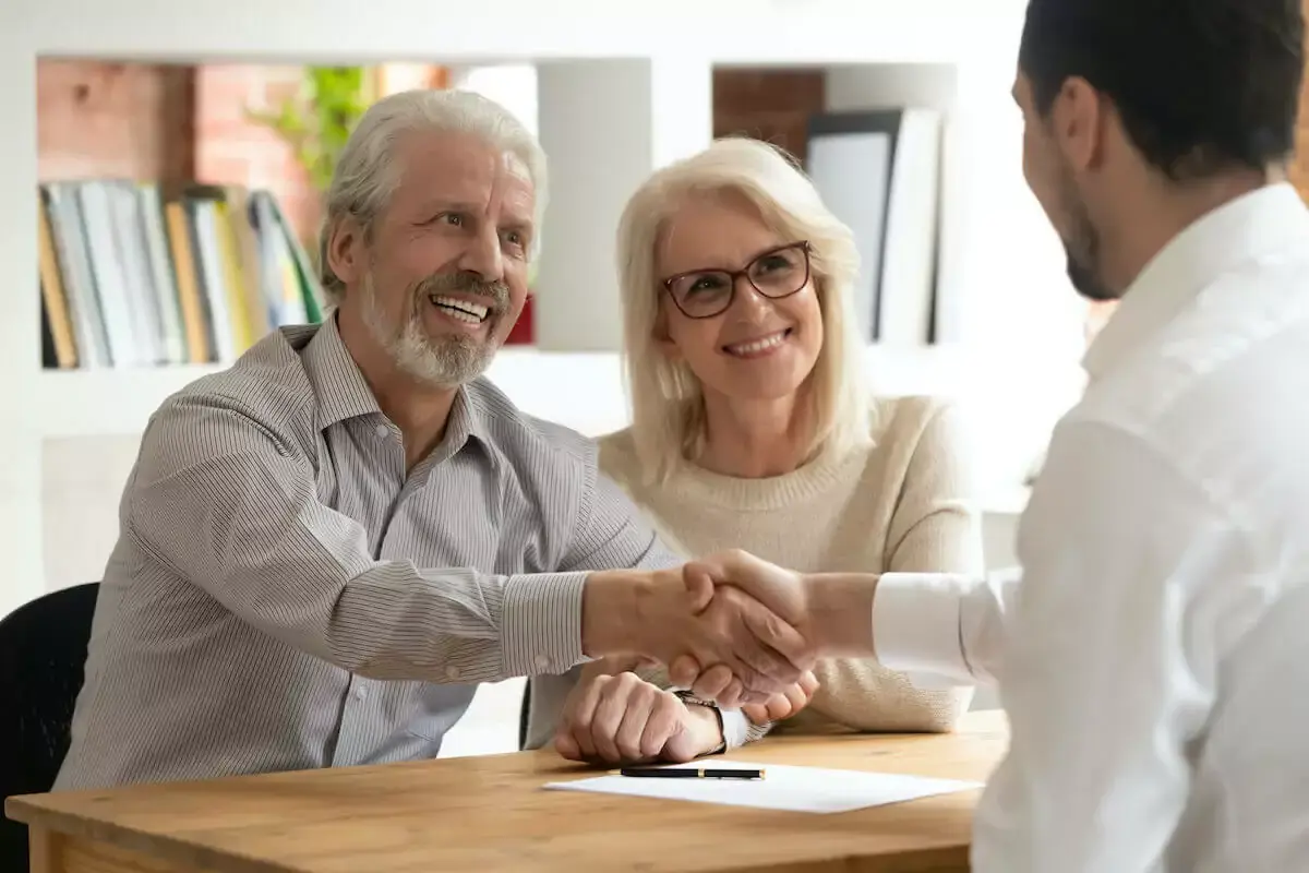 senior-couple-shaking-hands-with-another-man.jpg