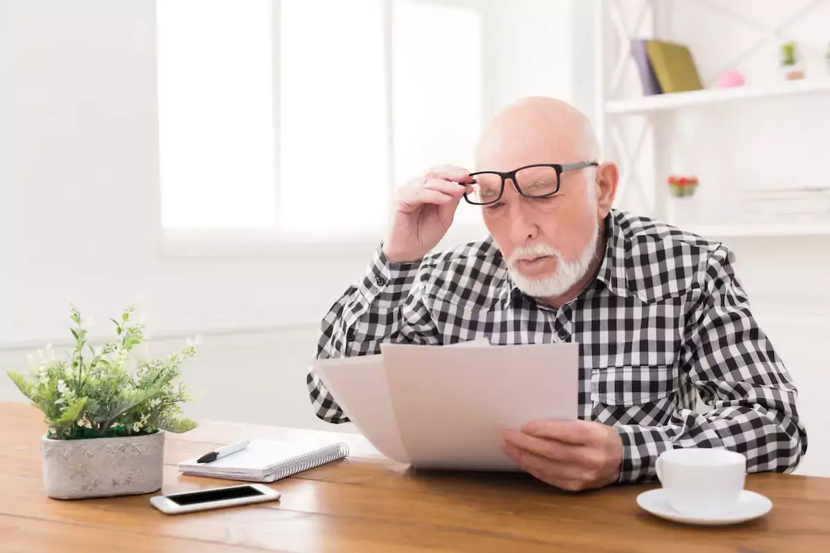 senior-man-reading-some-documents.jpeg