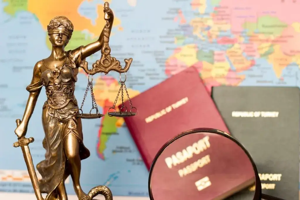 statue-with-a-world-map-magnifying-glass-and-2-passports-in-the-background-1024x683.jpeg