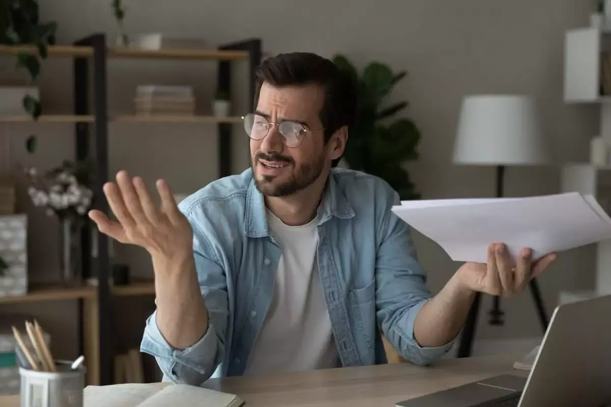 stressed-man-holding-documents.jpeg