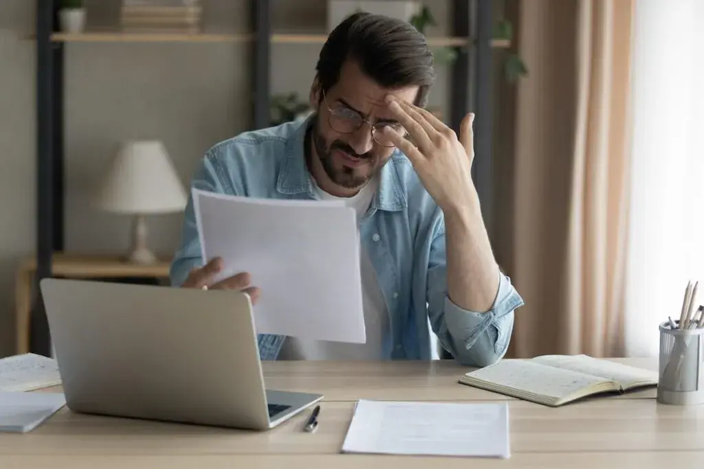 stressed-man-reading-some-documents-1024x683.jpeg