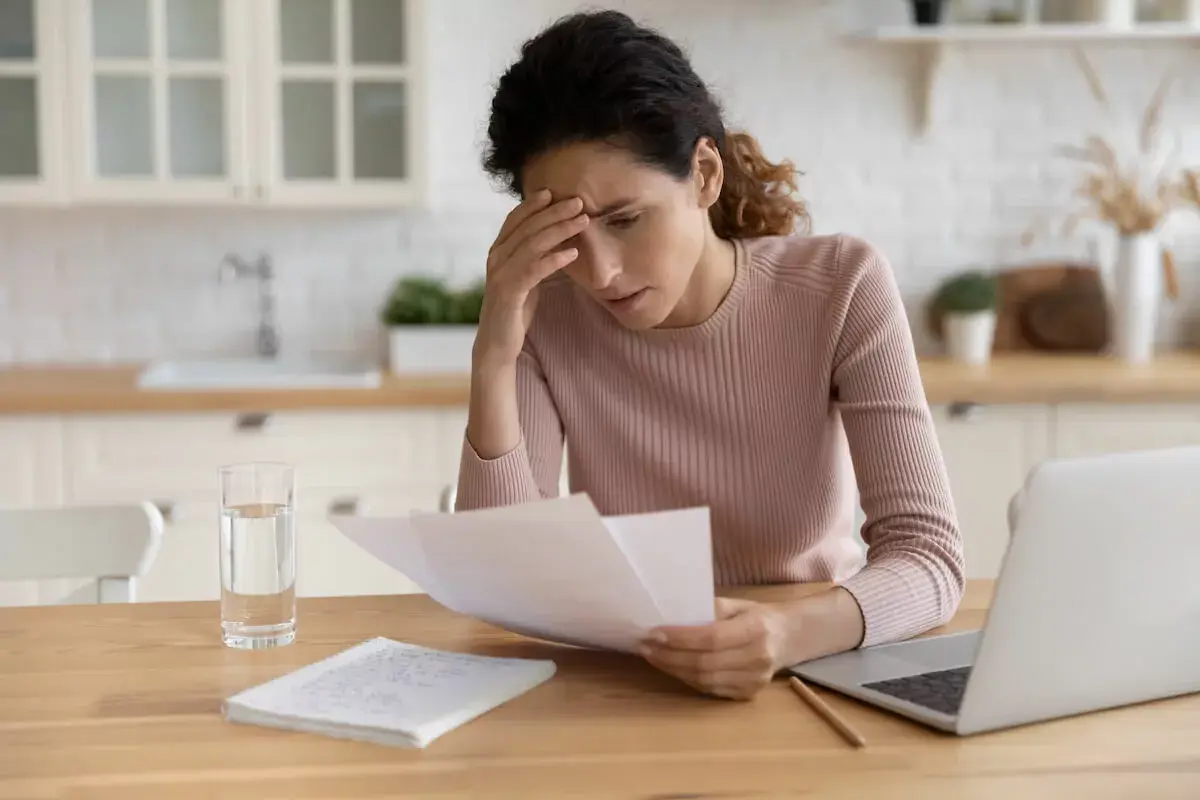 stressed-woman-reading-documents.jpeg