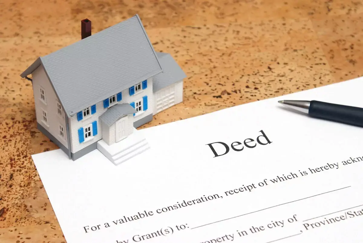toy-house-and-a-Deed-contract.jpeg