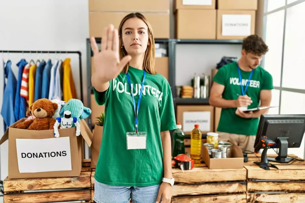 volunteer-doing-a-stop-sign-using-her-hand.jpeg
