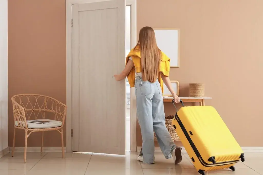 woman-pulling-her-suitcase-as-she-walks-out-of-her-house-1024x683.jpeg