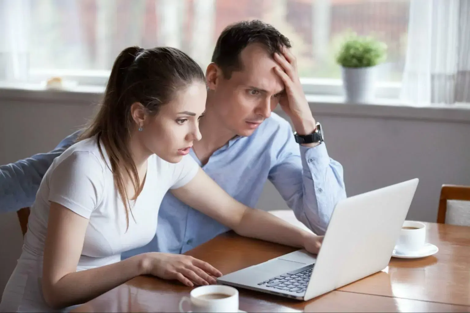 worried-couple-looking-at-their-laptop-1536x1024.jpg