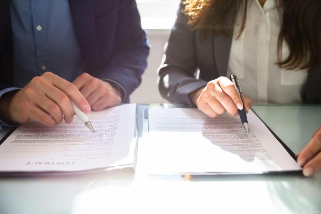 Close-up of a man and woman reviewing a contract