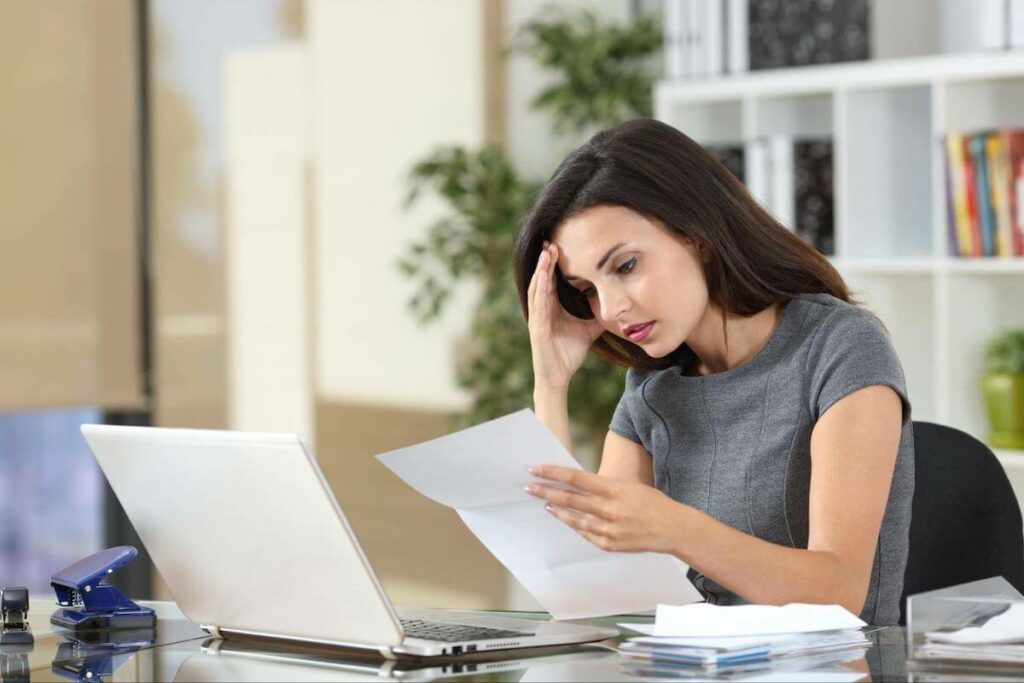 timeshare cancellation: stressed woman reading a contract