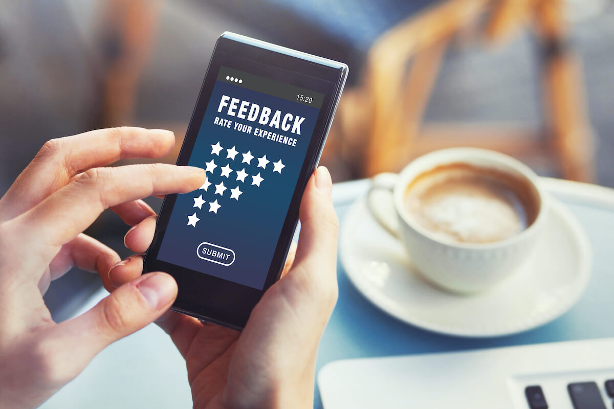 ratings and reviews of timeshare exit companies: person giving feedback on his mobile phone