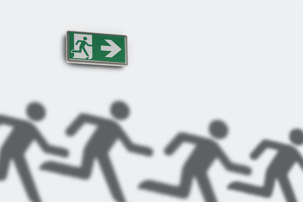 how to get out of a timeshare: Outline of people running with emergency exit sign against a white background
