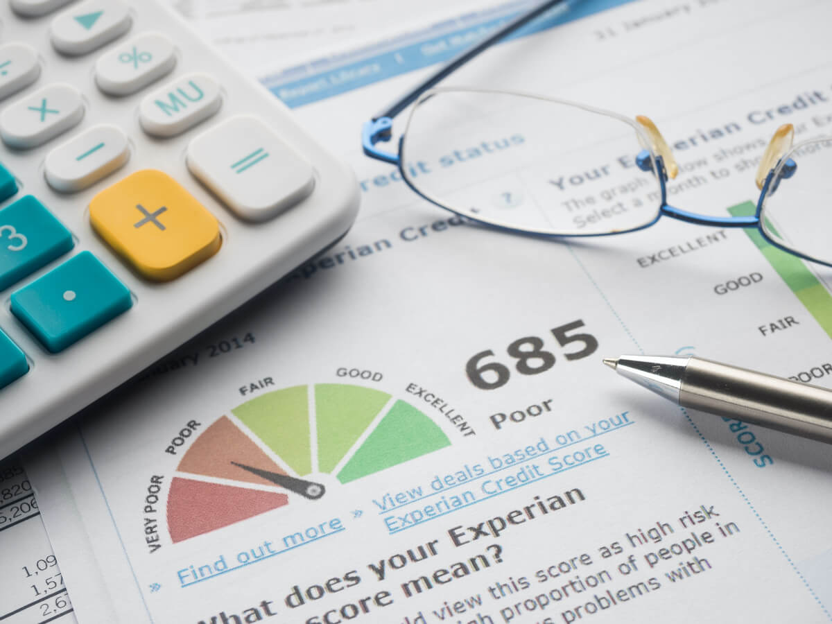Credit report, eyeglasses and calculator