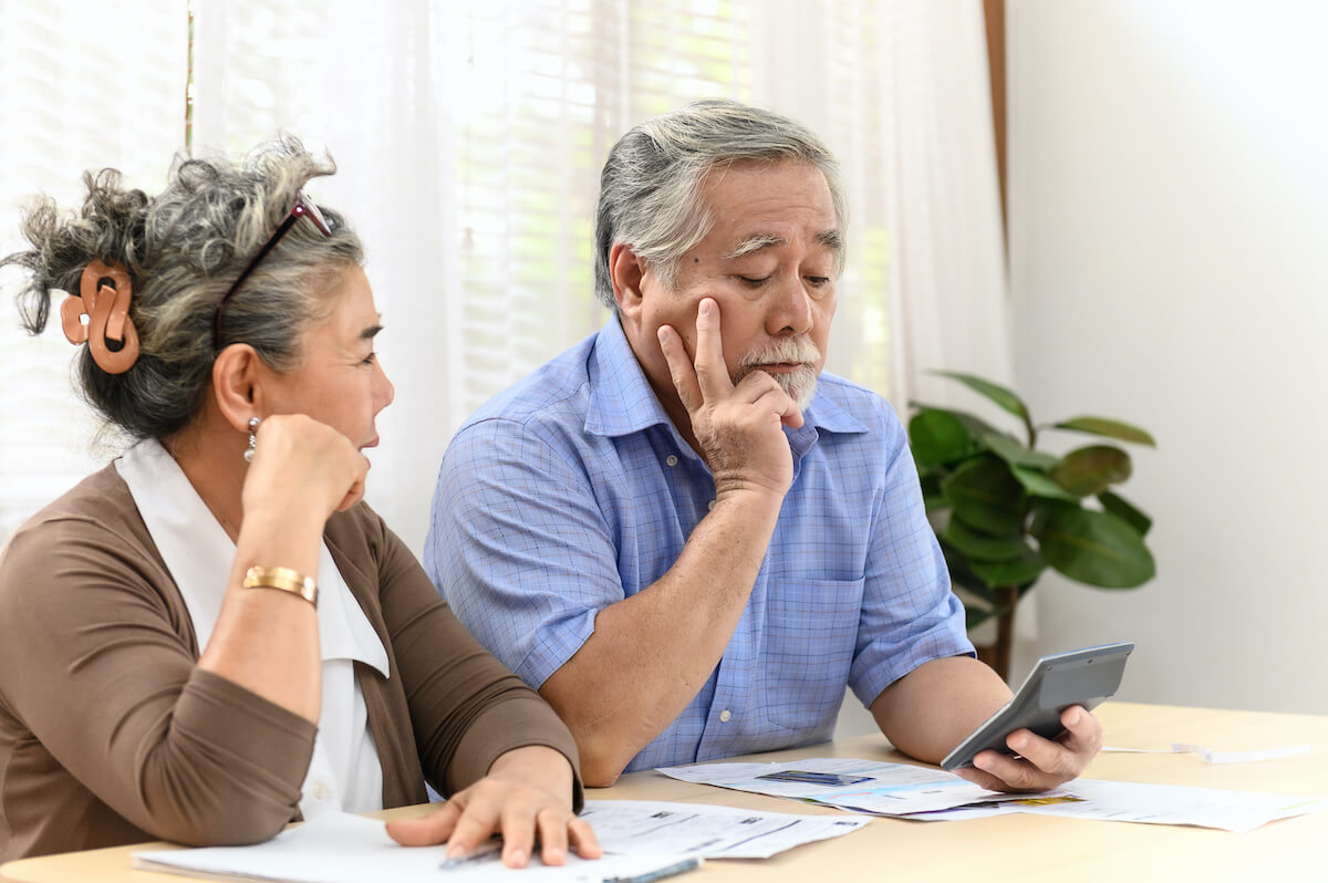 Elderly couple computing their finances