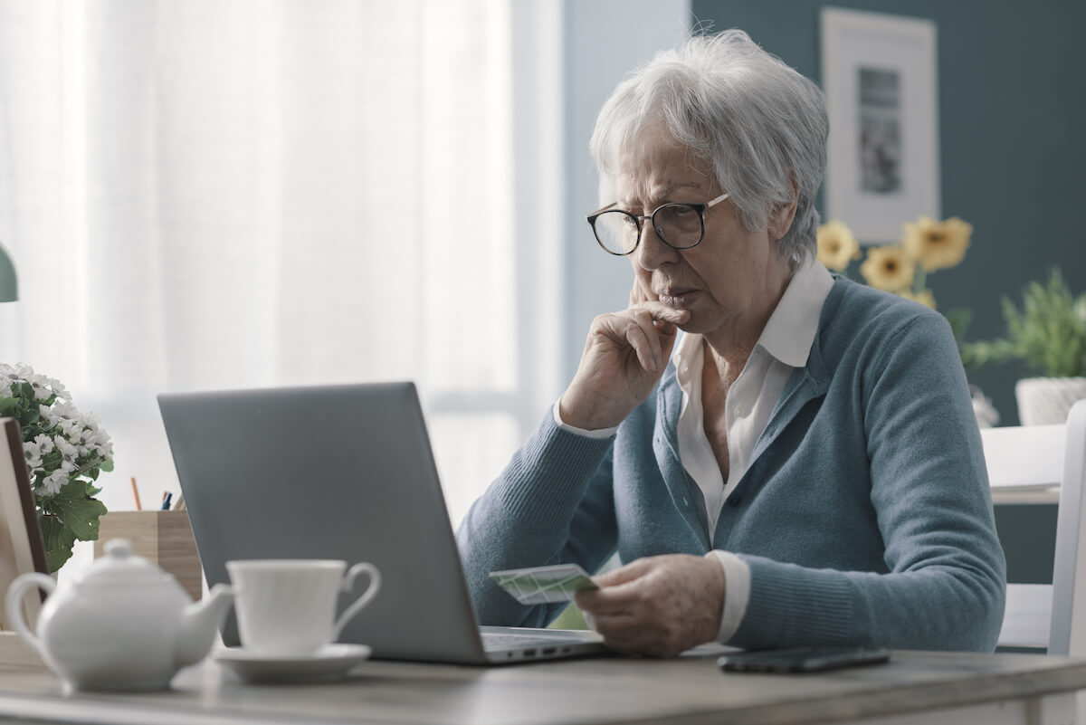 Timeshare exchange: elderly woman checking something online