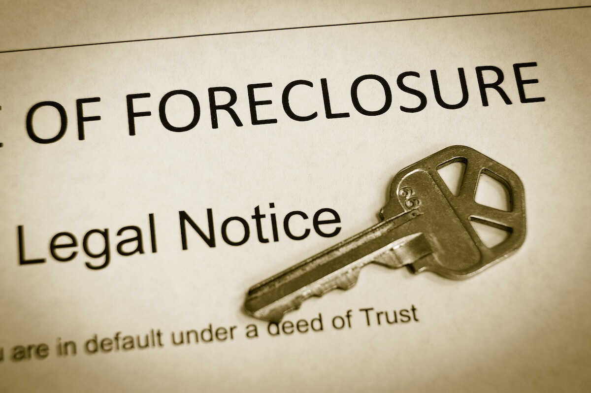 Timeshare foreclosure: key on top of a Foreclosure Legal Notice document