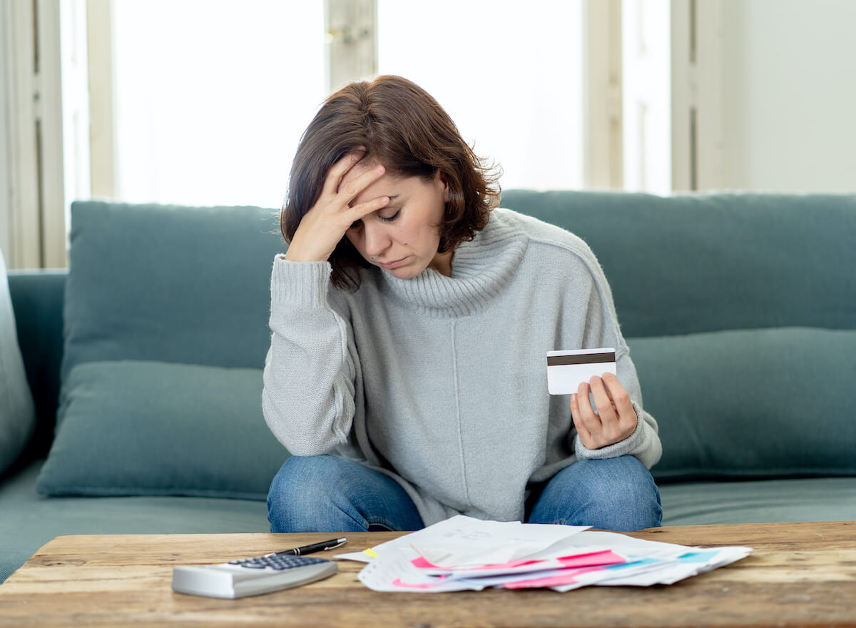 Why are timeshares bad: woman stressed with her bills