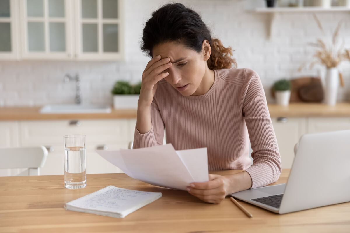 Timeshare Termination Team: stressed woman reading documents