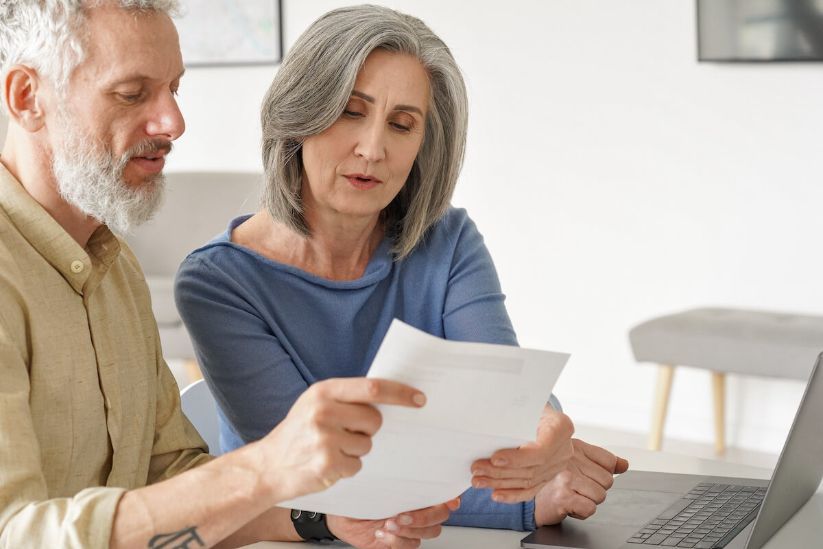 Are timeshares a good investment: elderly couple checking bank statements