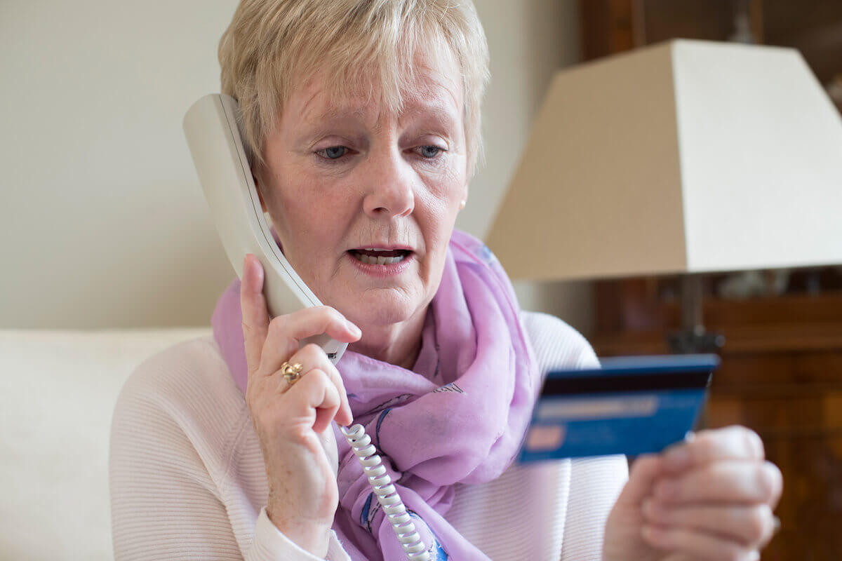 Best companies to sell timeshare: elderly woman giving her credit card details over the phone