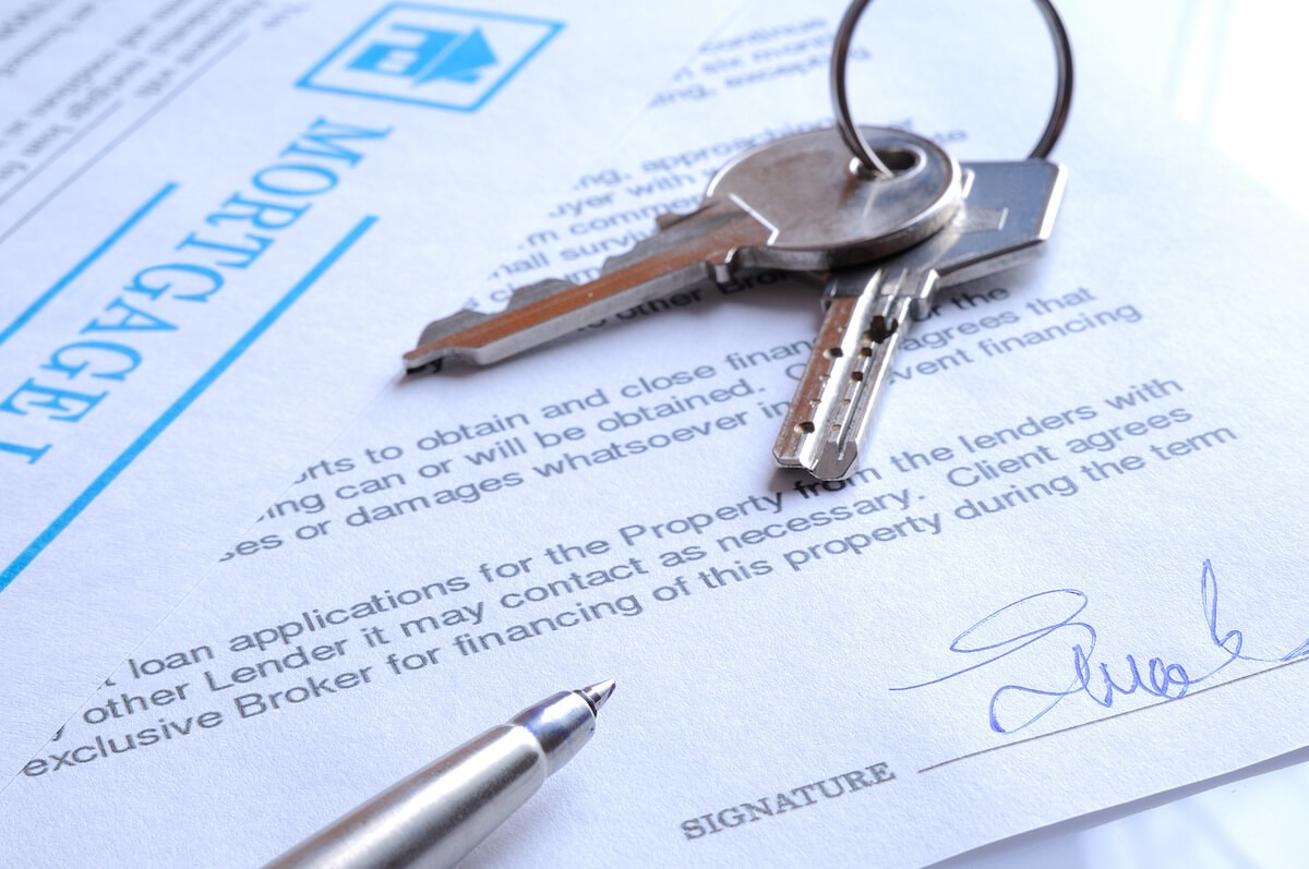 Timeshare price: keys on top of a signed mortgage document