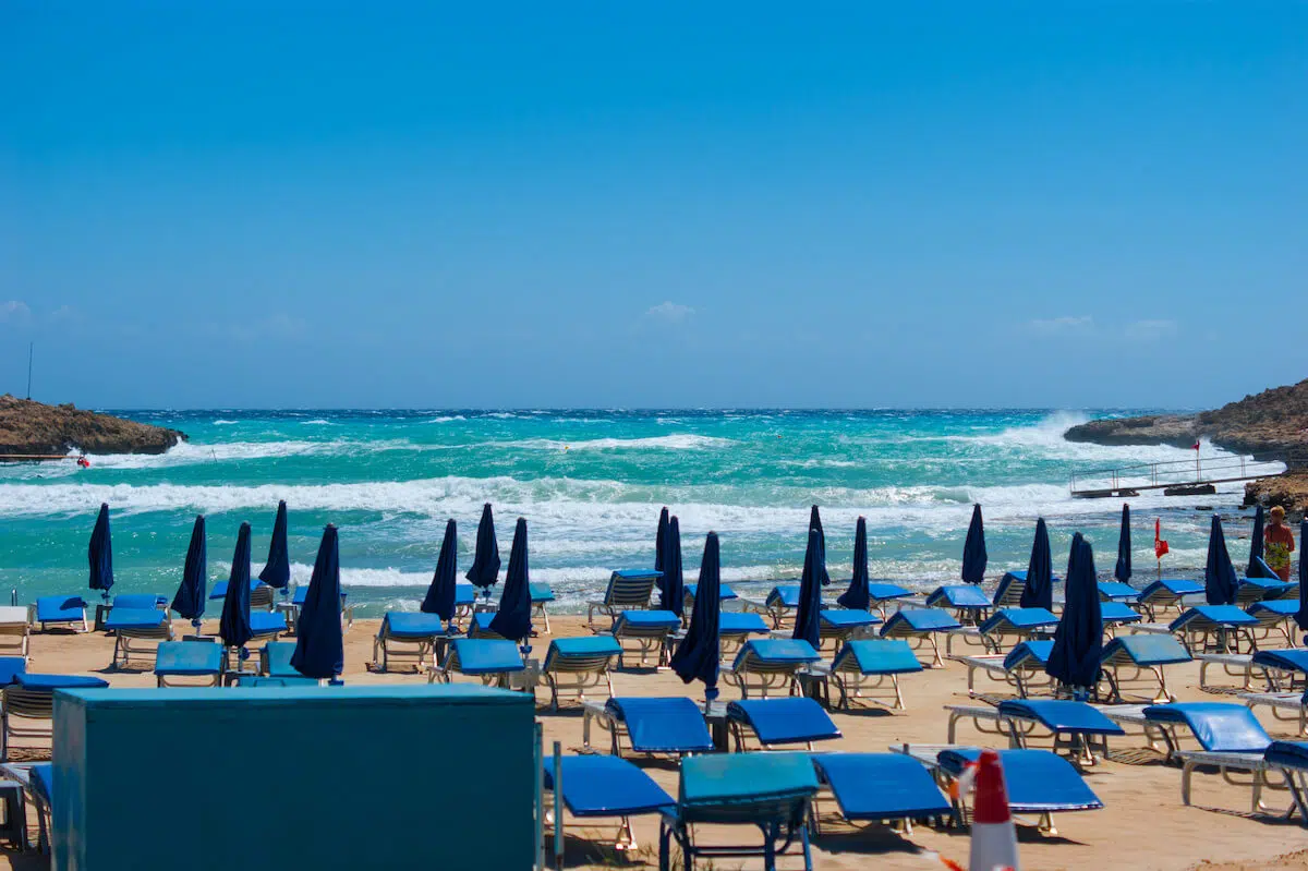 Wyndham scams: beautiful beach with blue umbrellas