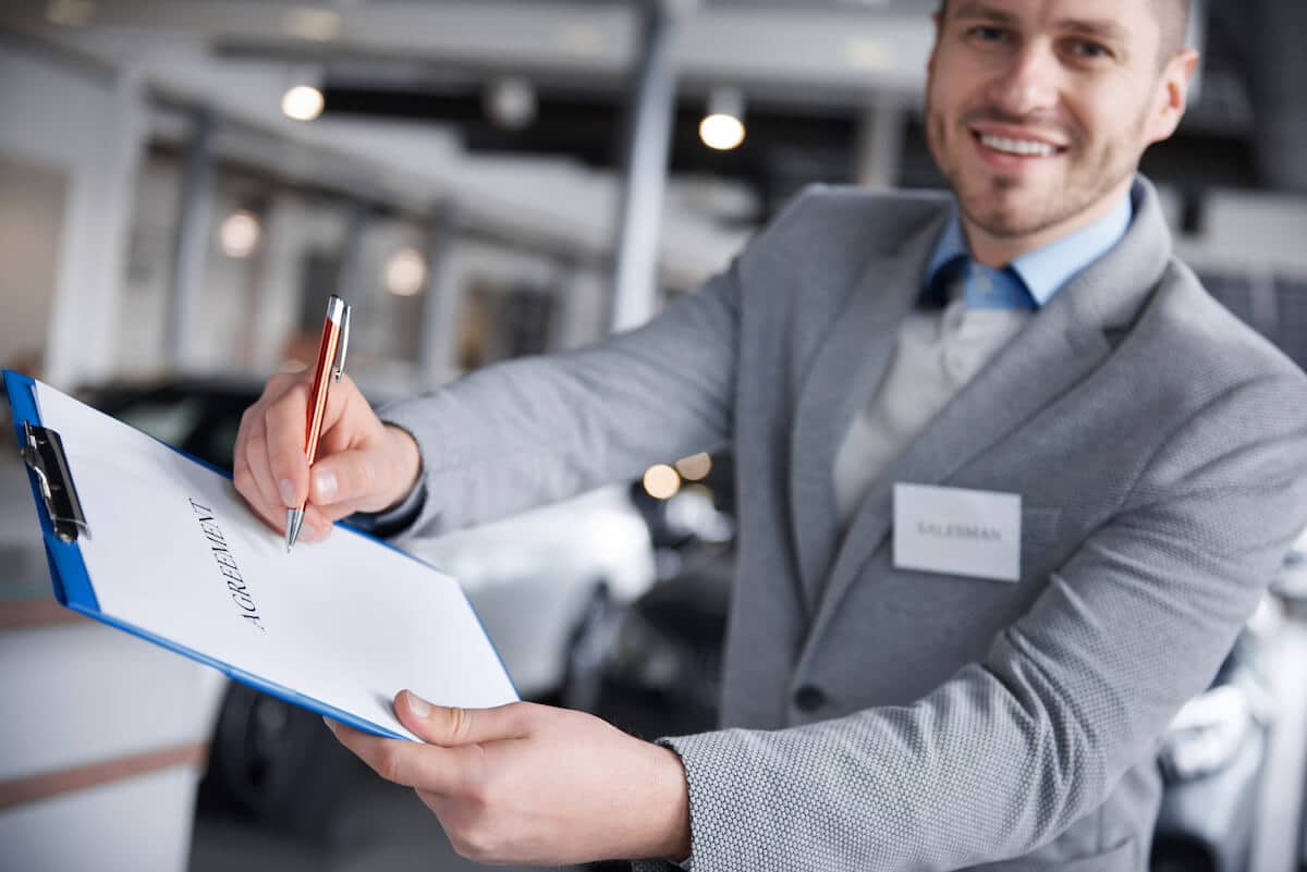 Salesperson handing an agreement document
