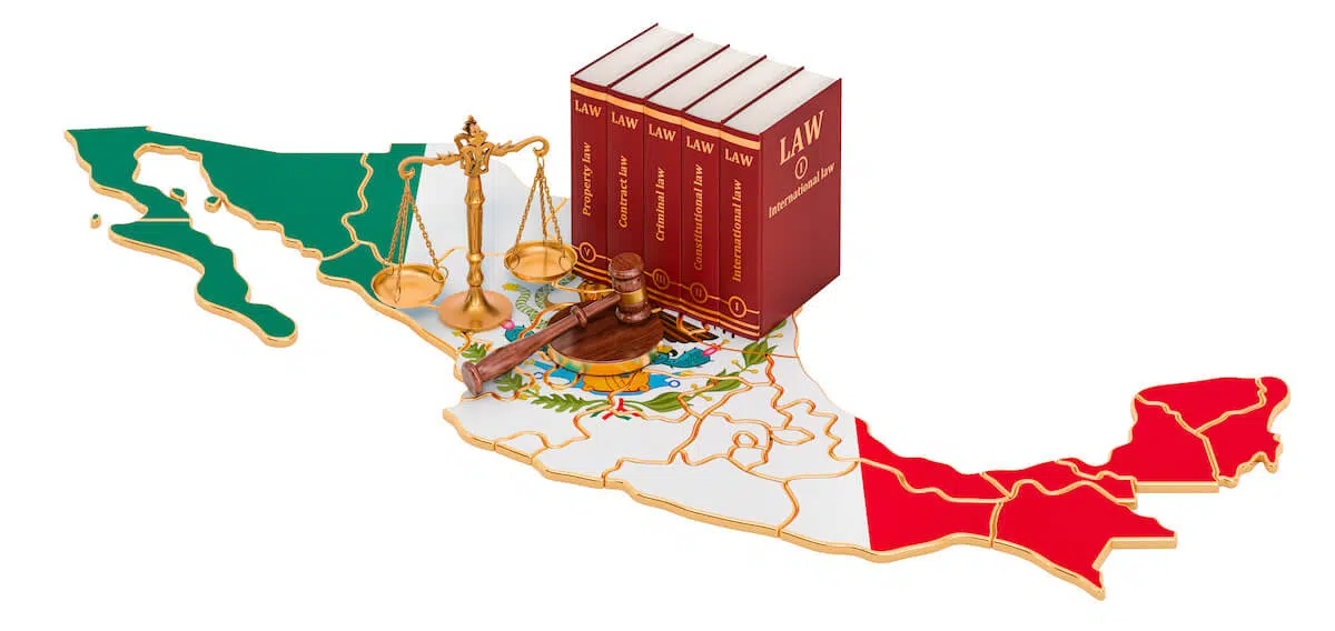 Law books, justice balance scale, and a hammer and gavel on top of a map of Mexico