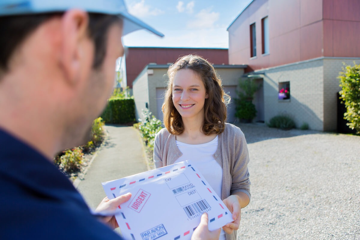 Courier handing mail to a person